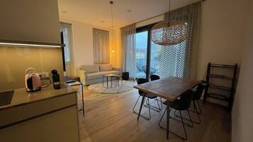 A modern apartment with a kitchen, dining area, and living space.
