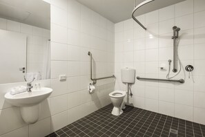 A bathroom with a white sink, toilet, and shower. - Quest Bundoora (Bundoora)