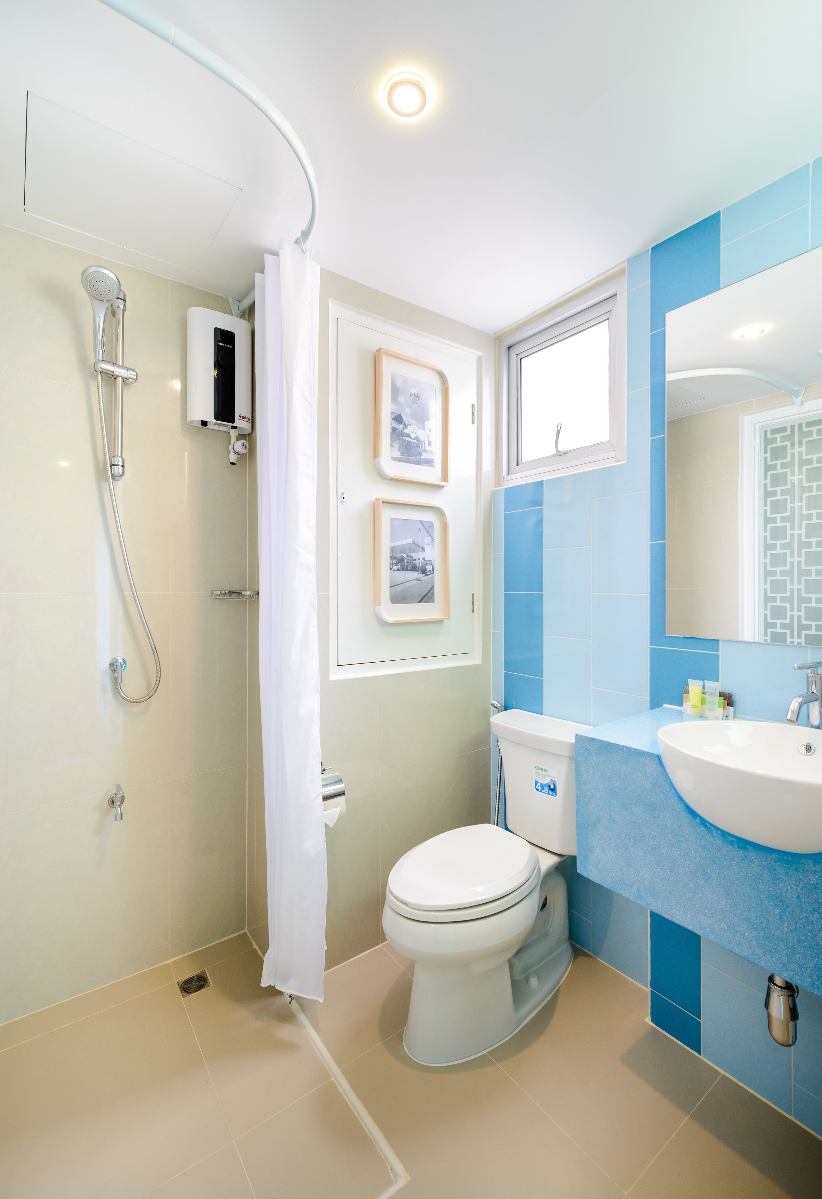 A modern bathroom with a shower, toilet, and sink.