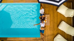 An aerial view of a swimming pool with wooden flooring and white lounge chairs. - The Tint at Phuket town (Phuket)