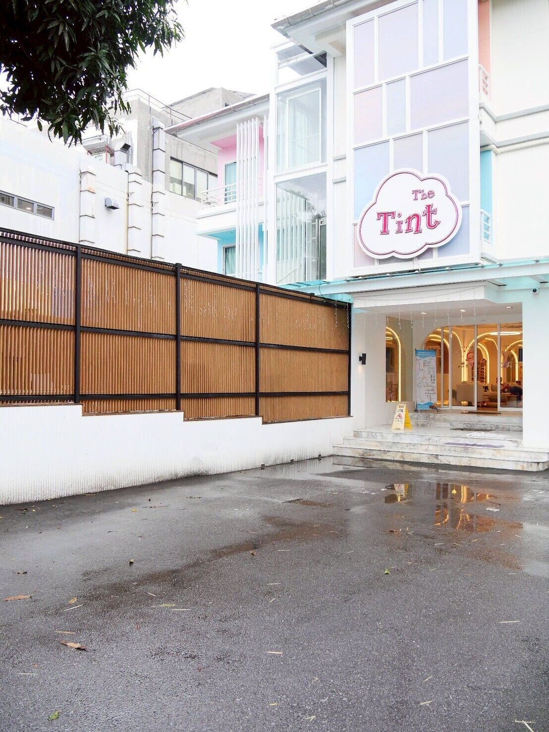 A building with a sign reading "The Tint".