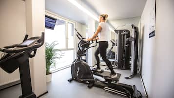 A gym with cardio equipment, a treadmill, and a stationary bike.