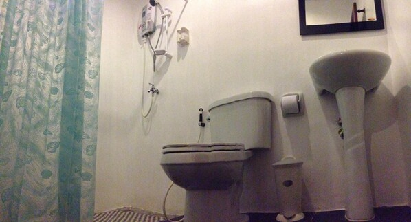 A bathroom with a toilet, a bidet, and a showerhead. - Phuket Muay Thai House (Chalong)