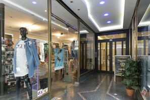 Ein Schaufenster mit einer Büste, die eine Jeansjacke und ein weißes Hemd präsentiert.