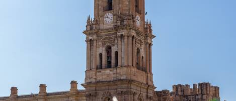 A historic building with a prominent bell tower and arched windows.