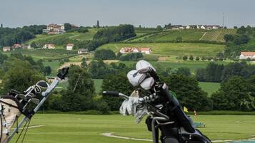 Golfers can enjoy a serene game amidst lush green fields and rolling hills.