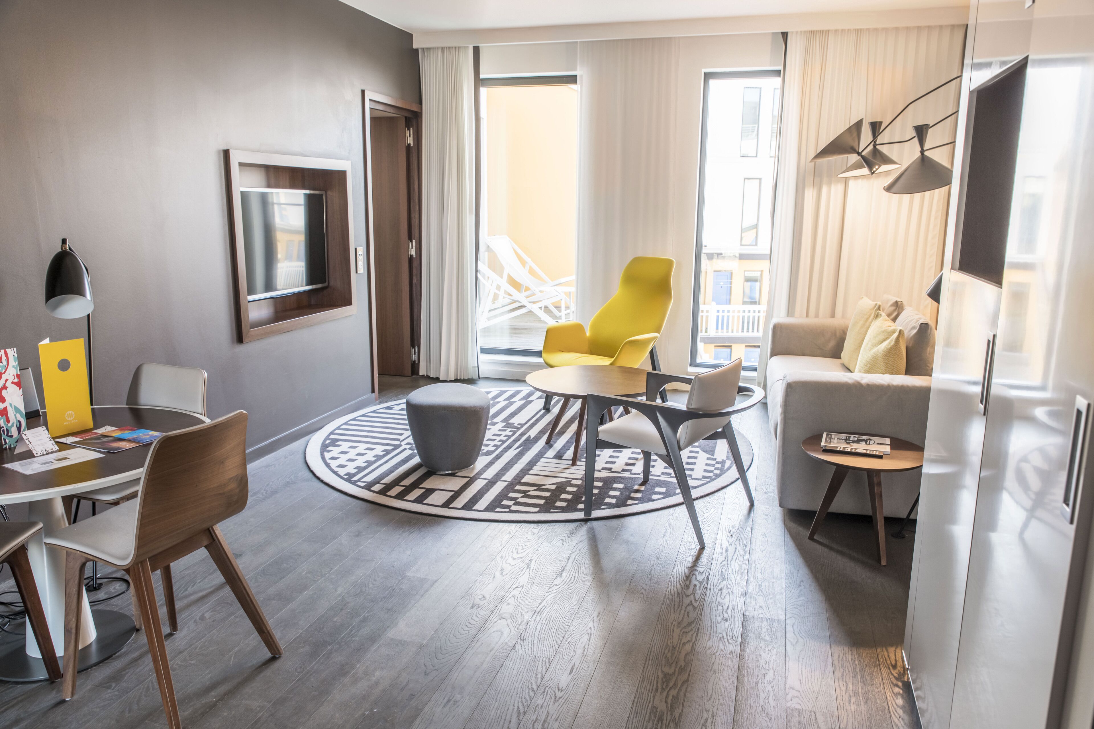 suite, 1 king bed with sofa bed, balcony, pool view | living area | 40-inch tv with cable channels, table football, books