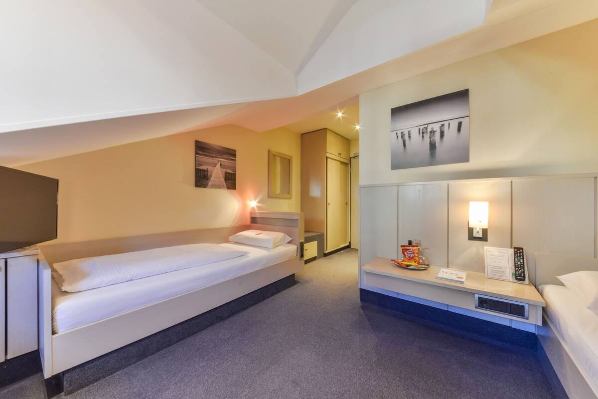 Junior Twin Room, sloping roof | In-room safe, desk, blackout drapes, soundproofing