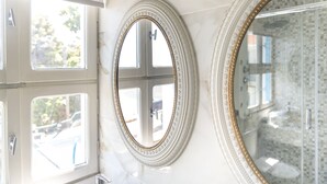 Three oval mirrors with decorative frames on a wall. - Hotel Agia Markella (Chios)