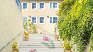 A staircase leading to a hotel entrance with a sign reading "HOTEL MAPKEAAA." - Hotel Agia Markella (Chios)