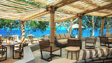 On the beach, white sand, sun loungers, beach towels