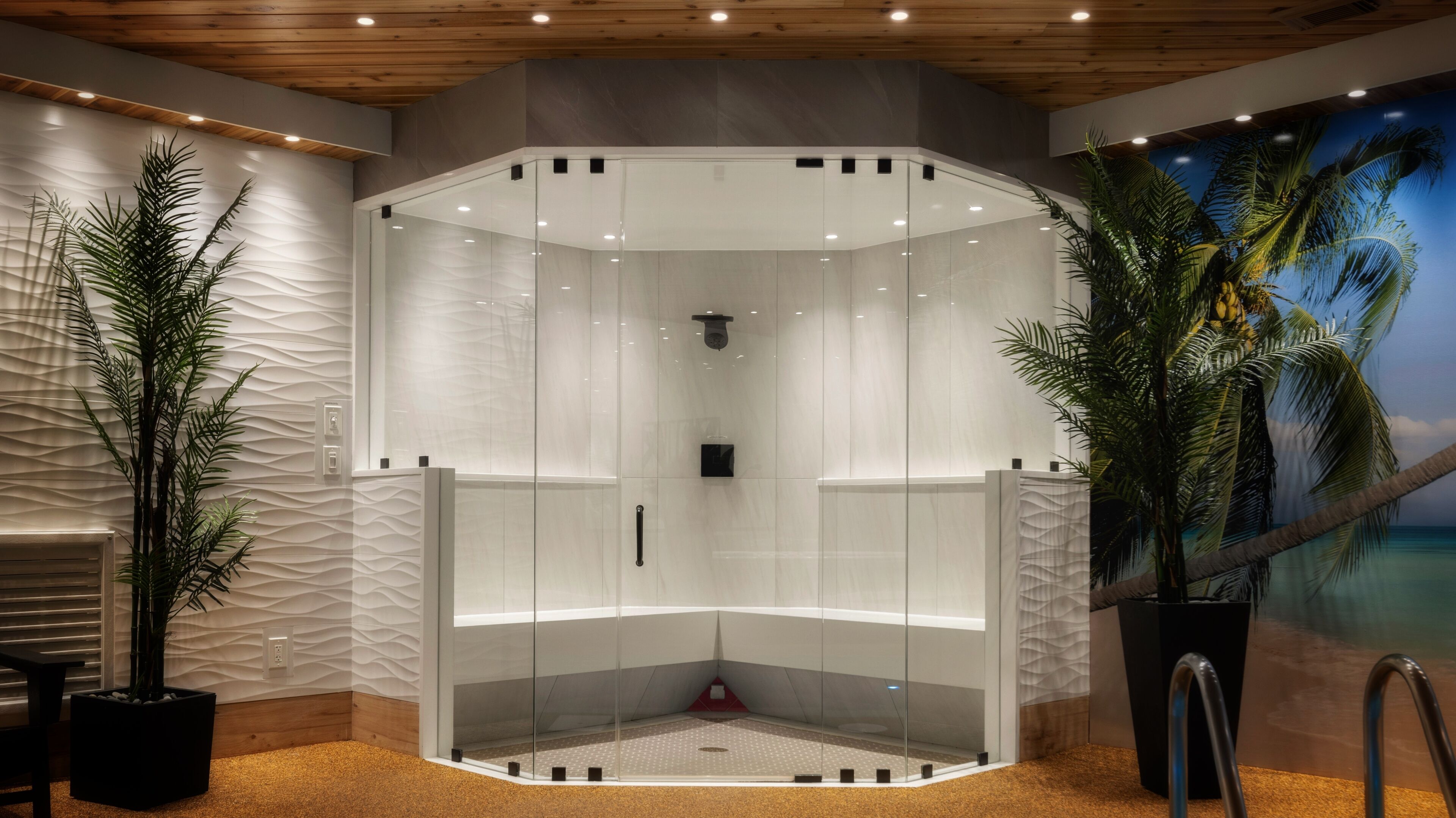 A modern shower room with a glass enclosure, wooden ceiling, and a tropical mural.