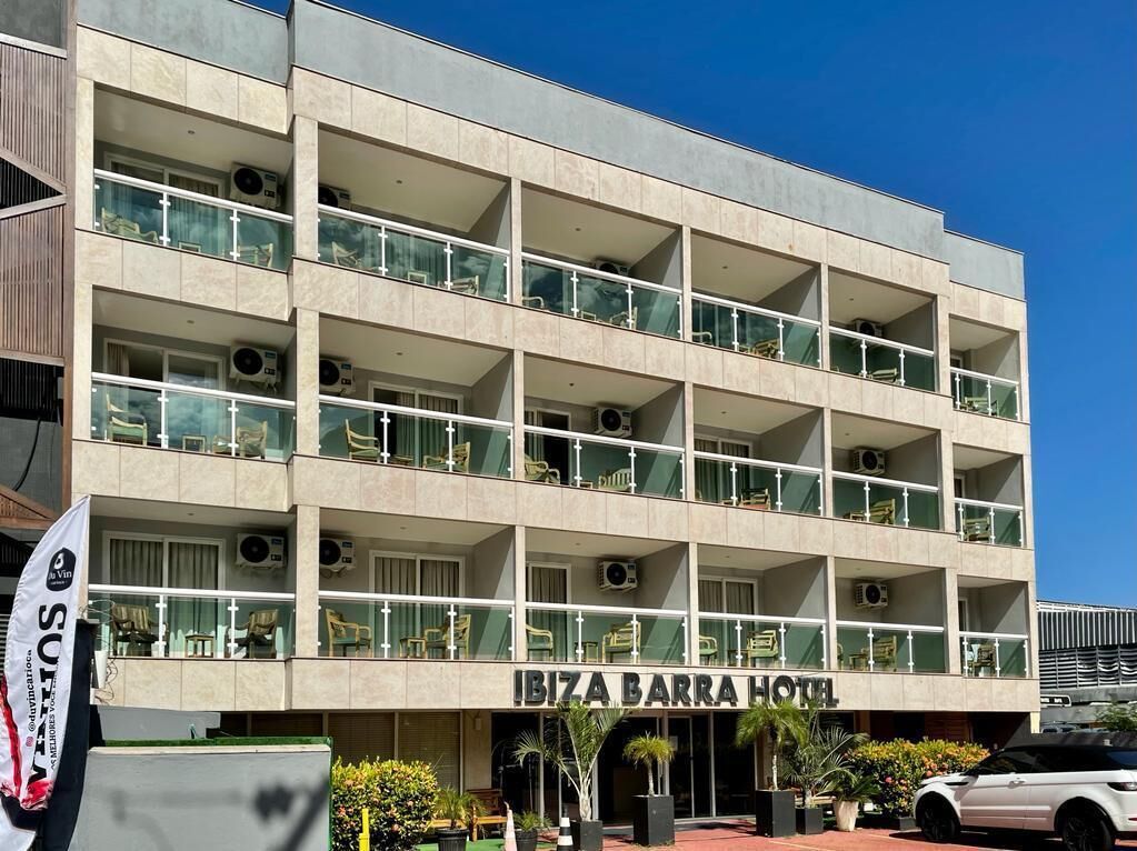 A multi-story building with balconies, labeled "IBIZA BARRA HOTEL".