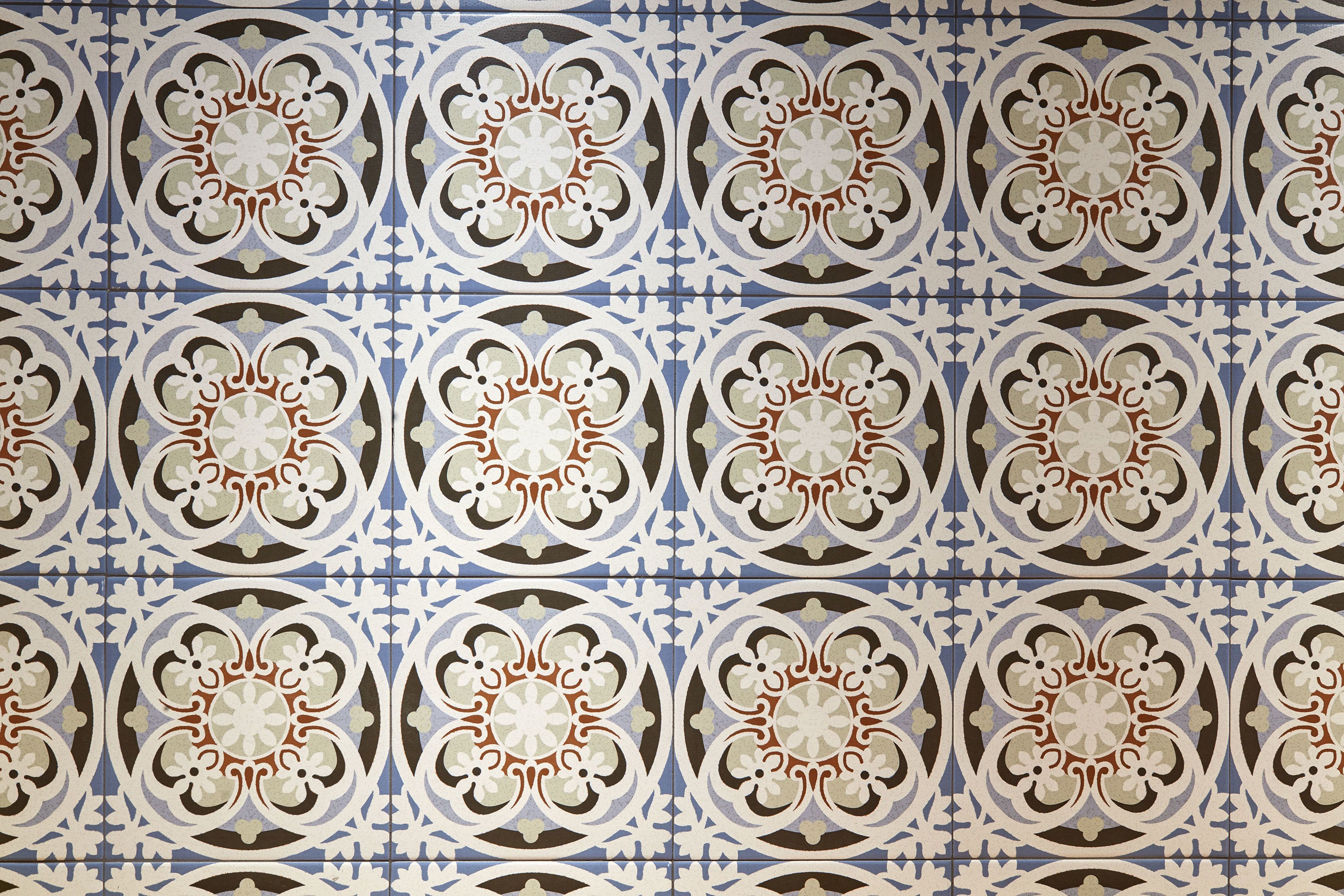 A patterned tile wall with a symmetrical design.