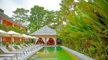 Een buitenzwembad, parasols voor strand/zwembad