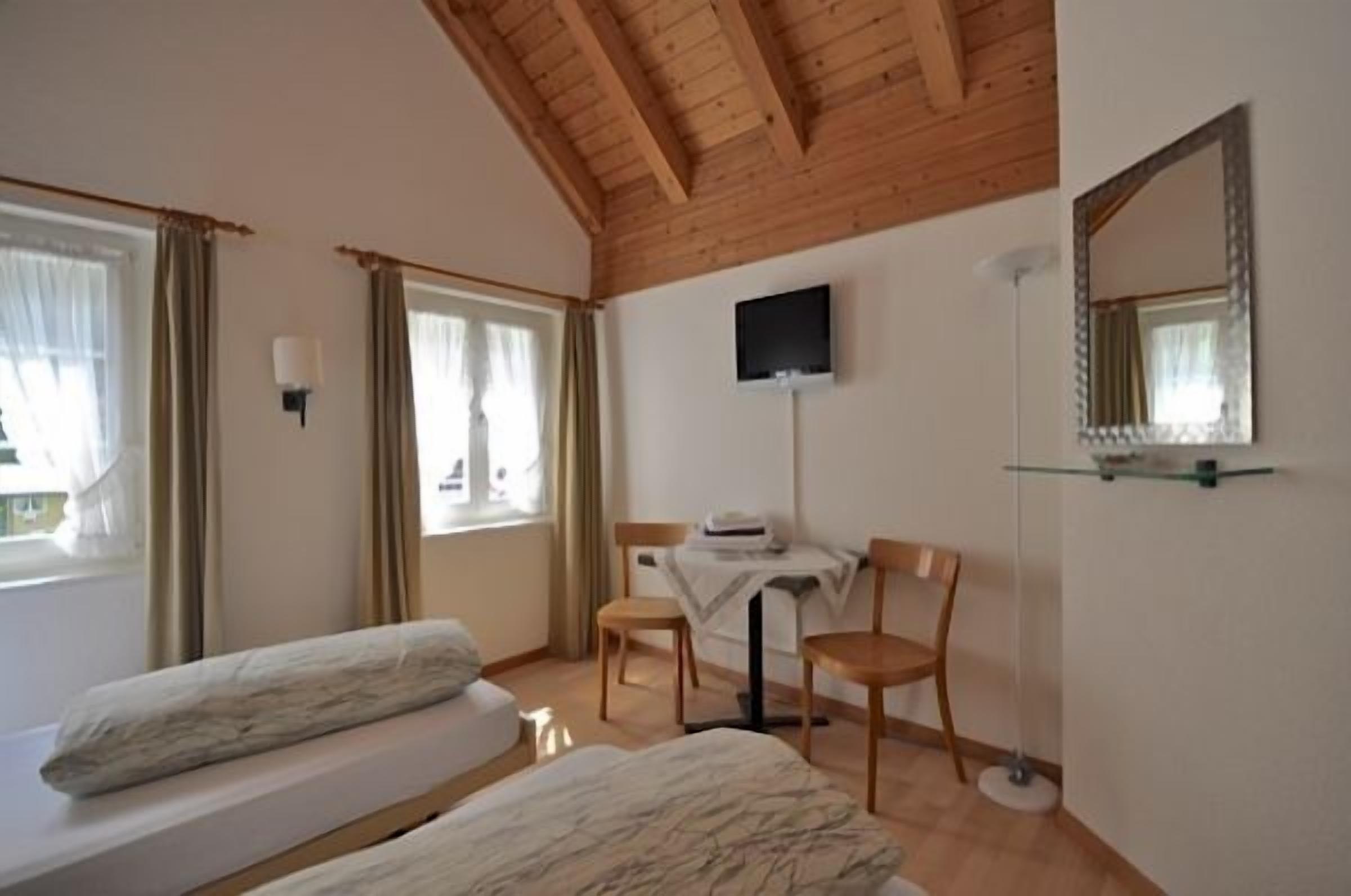 double room, shared bathroom | living area | plasma tv