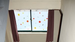 A staircase with a checkered floor, wooden steps, and a window with curtains. - Samwonjang Motel (Busan)