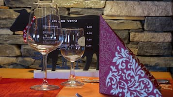 Two wine glasses on a table with a menu in the background.