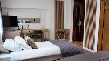 Superior Triple Room | Minibar, desk, laptop workspace, blackout drapes