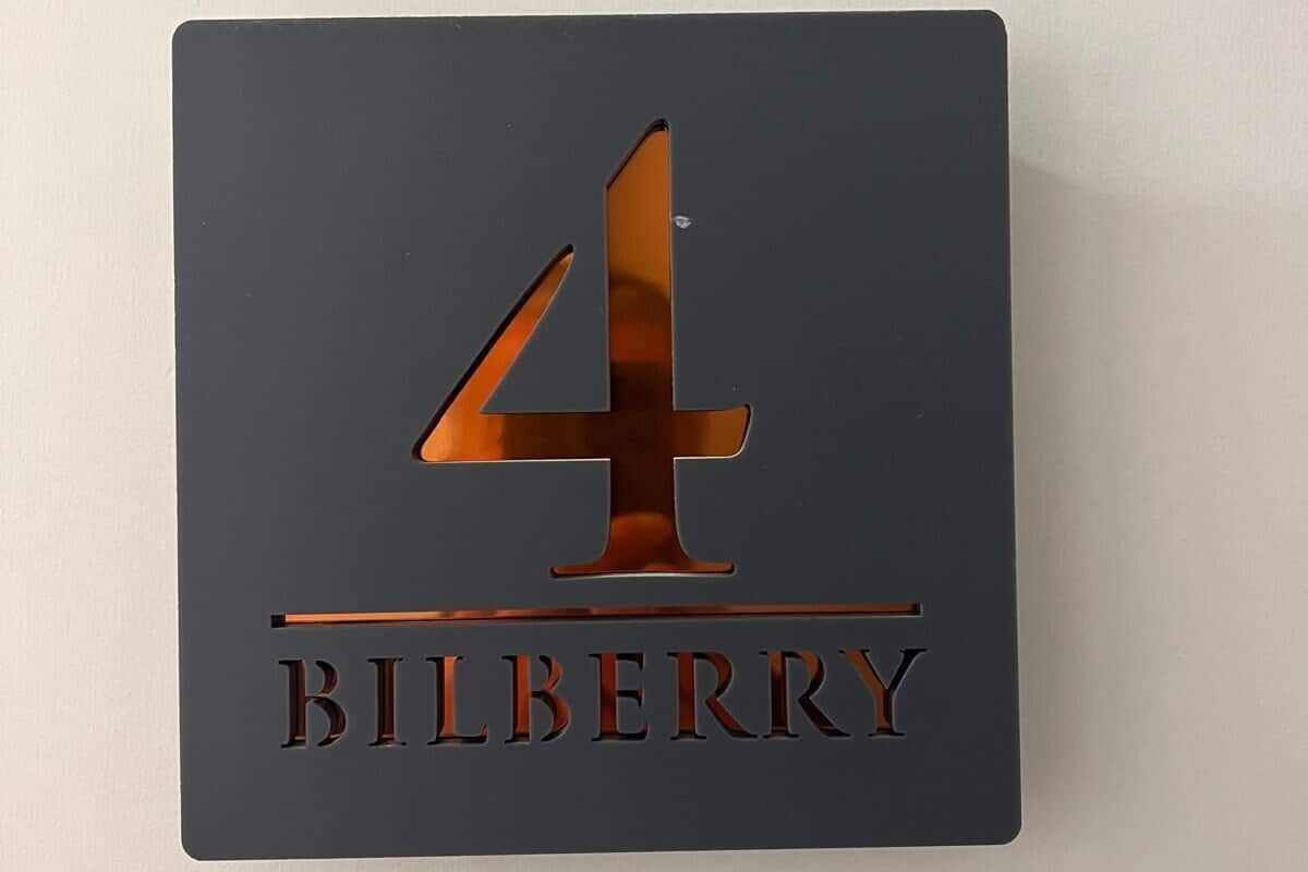 A sign with the number 4 and the word "BILBERRY" on a dark background.