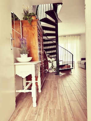 A staircase with a black railing leading to a landing.