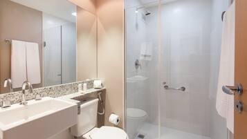 A modern bathroom with a sink, toilet, and glass-enclosed shower.