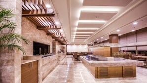 A modern kitchen with marble countertops, wooden cabinetry, and a central island. - Gorrion Hotel Istanbul (Istanbul)