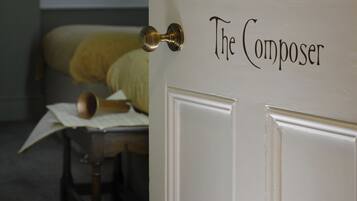 A door labeled "The Composer" with a brass doorknob.