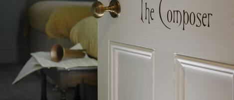 A door labeled "The Composer" with a brass doorknob.
