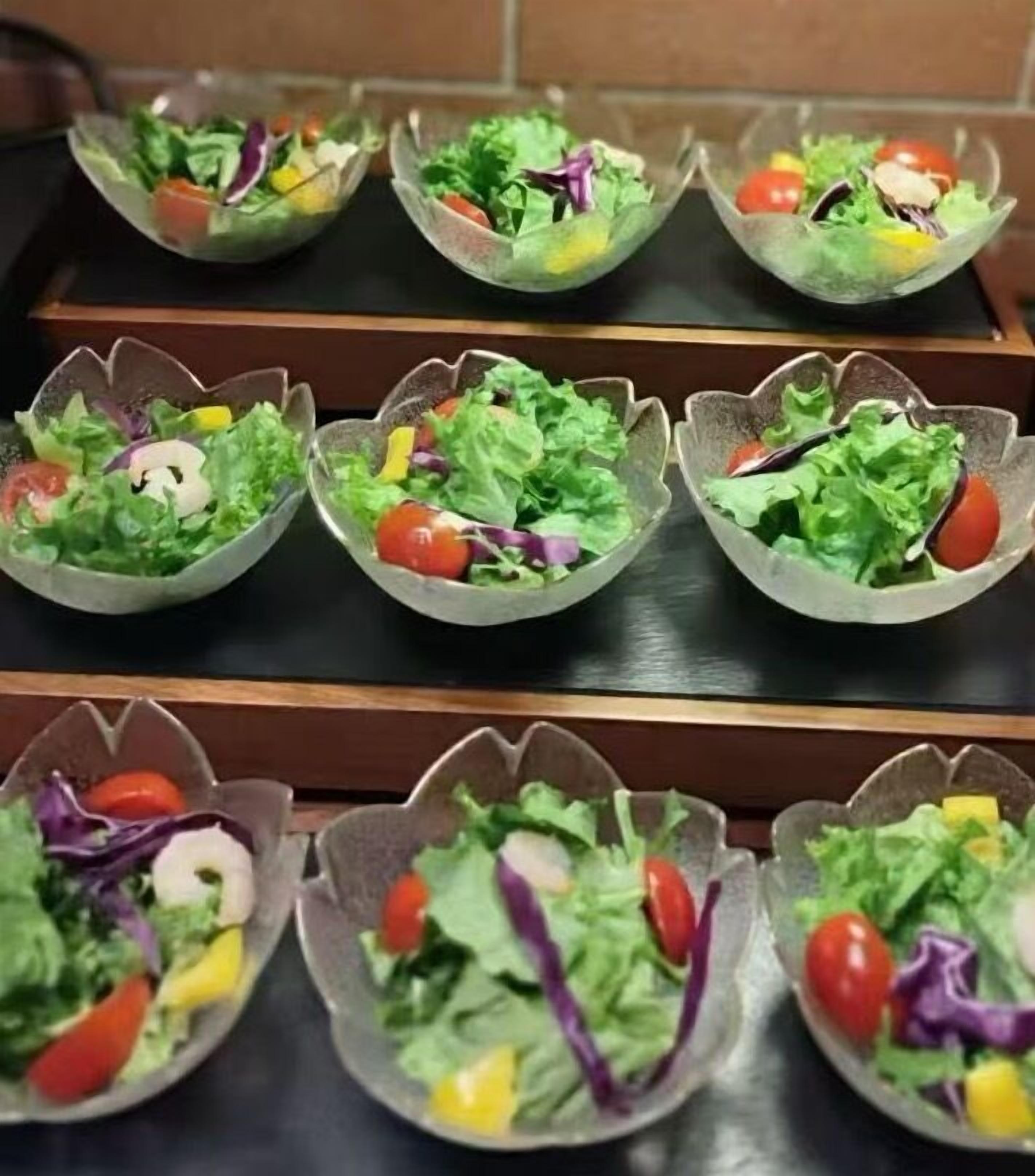 A row of salad bowls on a table.