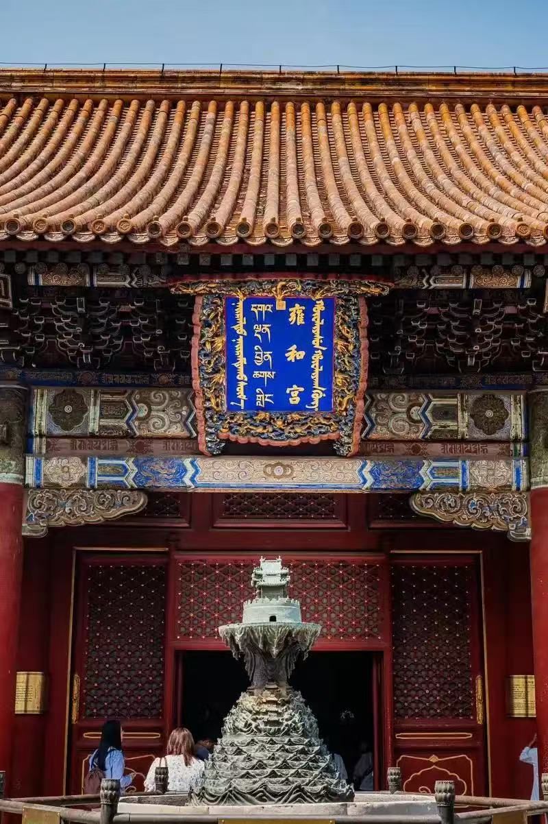 A traditional building with intricate roof tiles and a decorative banner.