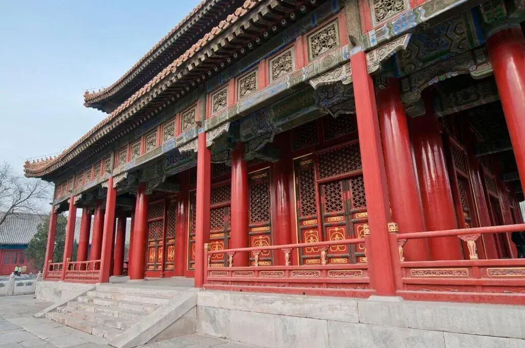 A traditional building with red columns and ornate decorations.