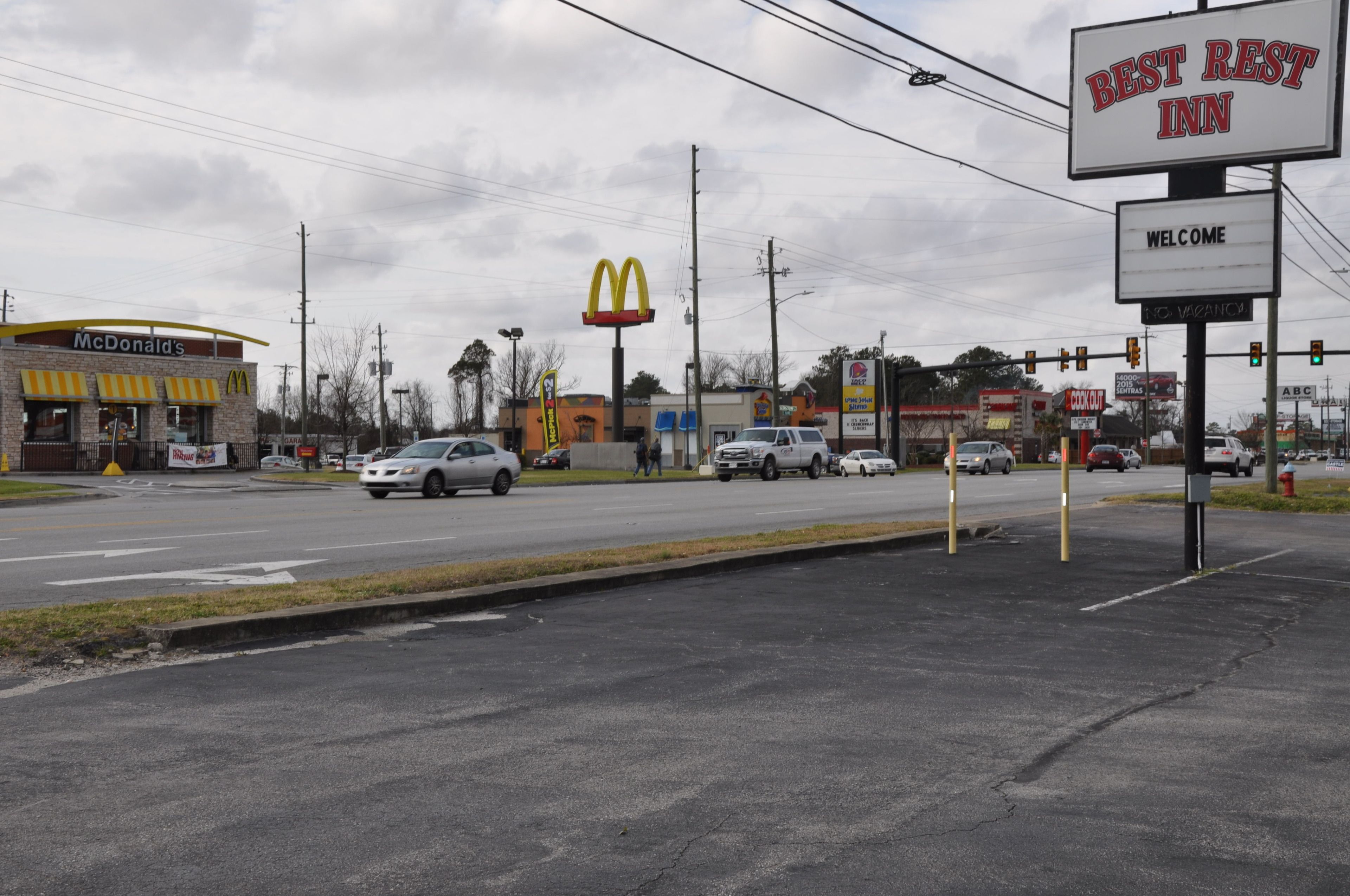 A McDonald's restaurant and a Best Rest Inn sign at a roadside intersection.
