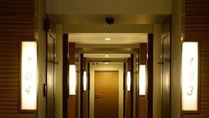 A hotel corridor with doors numbered 703, 704, and 705. - Honey Lodge (Pattaya)