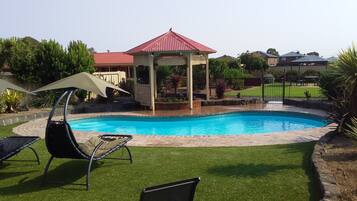 Outdoor pool, open 8 AM to 8 PM, pool loungers