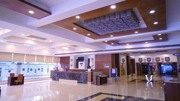 A modern hotel lobby with a reception desk, a large decorative ceiling, and a clean, polished floor. - Fortune Murali Park, Vijayawada - Member ITC Hotels' Group (Vijayawada)