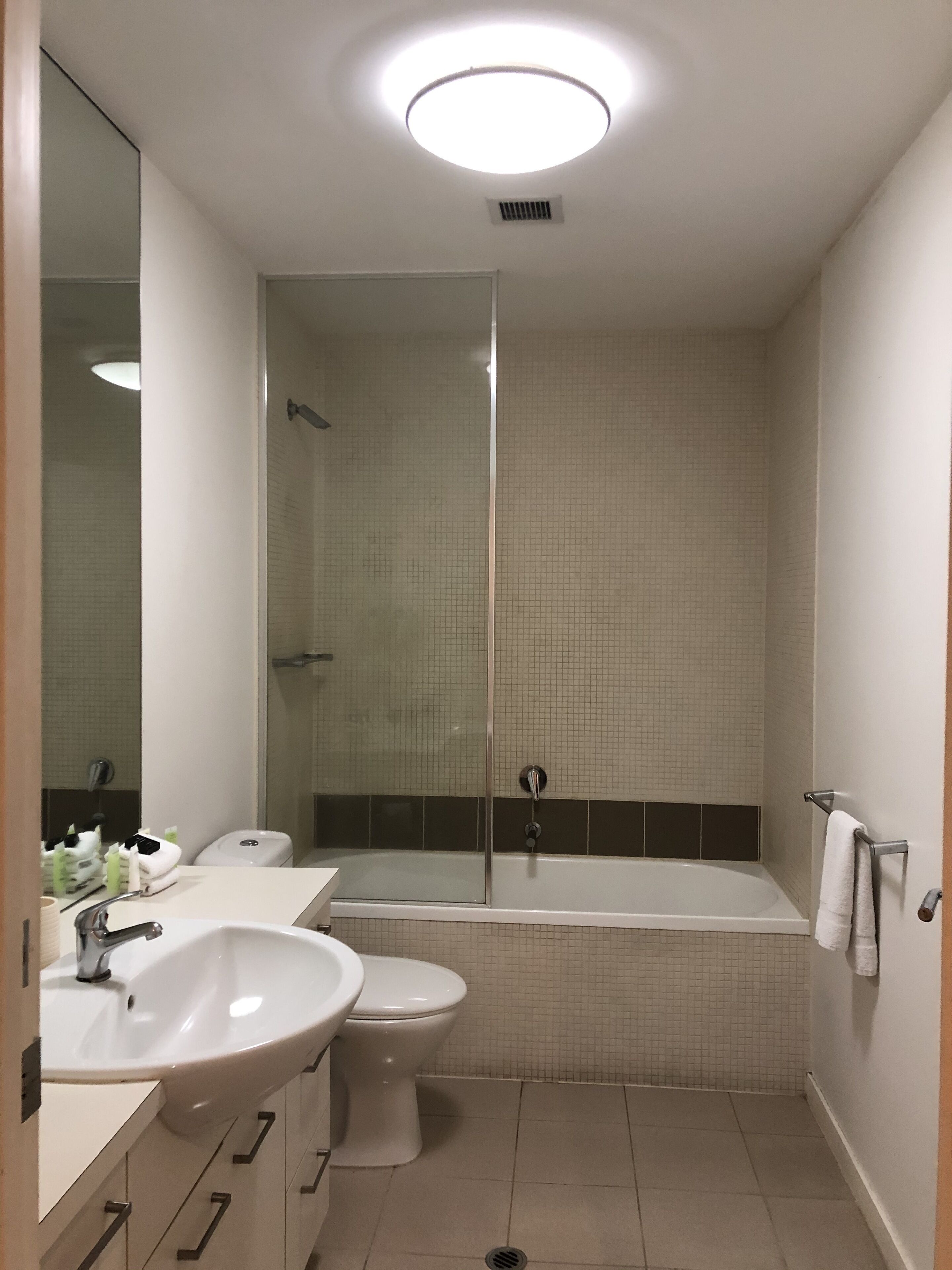 A bathroom with a sink, toilet, and shower.