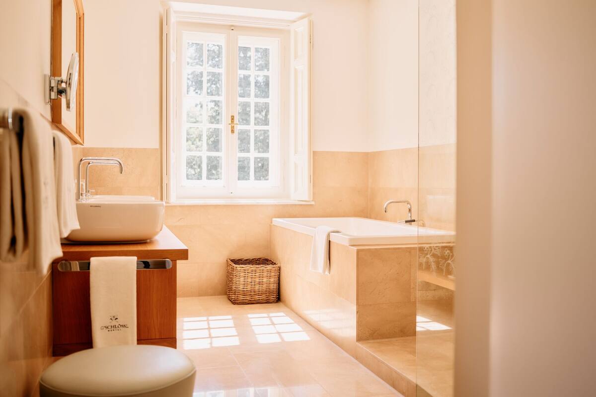 deluxe suite, 1 king bed | bathroom | hair dryer, bathrobes, slippers, towels