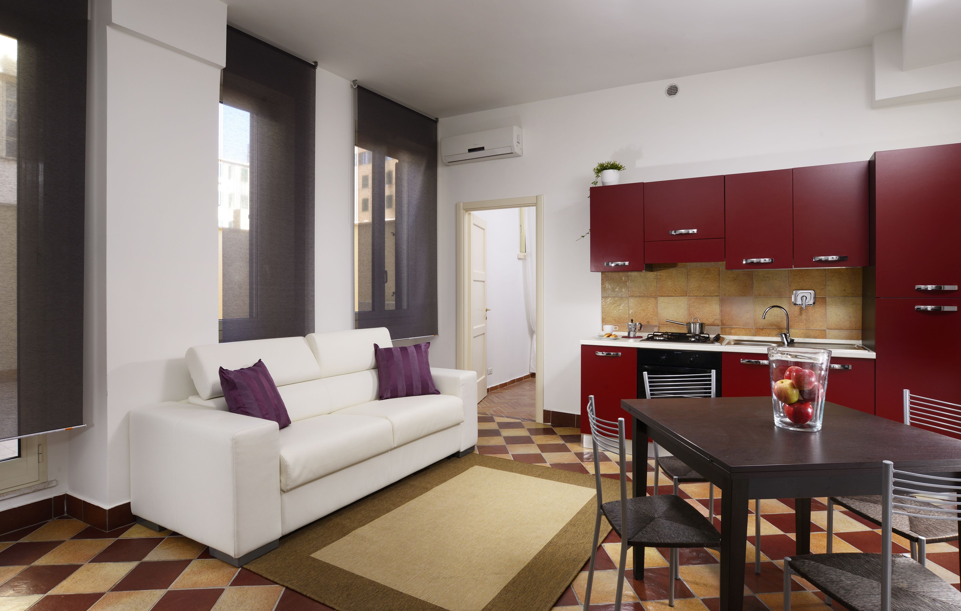A modern apartment with a living area, kitchen, and dining space.