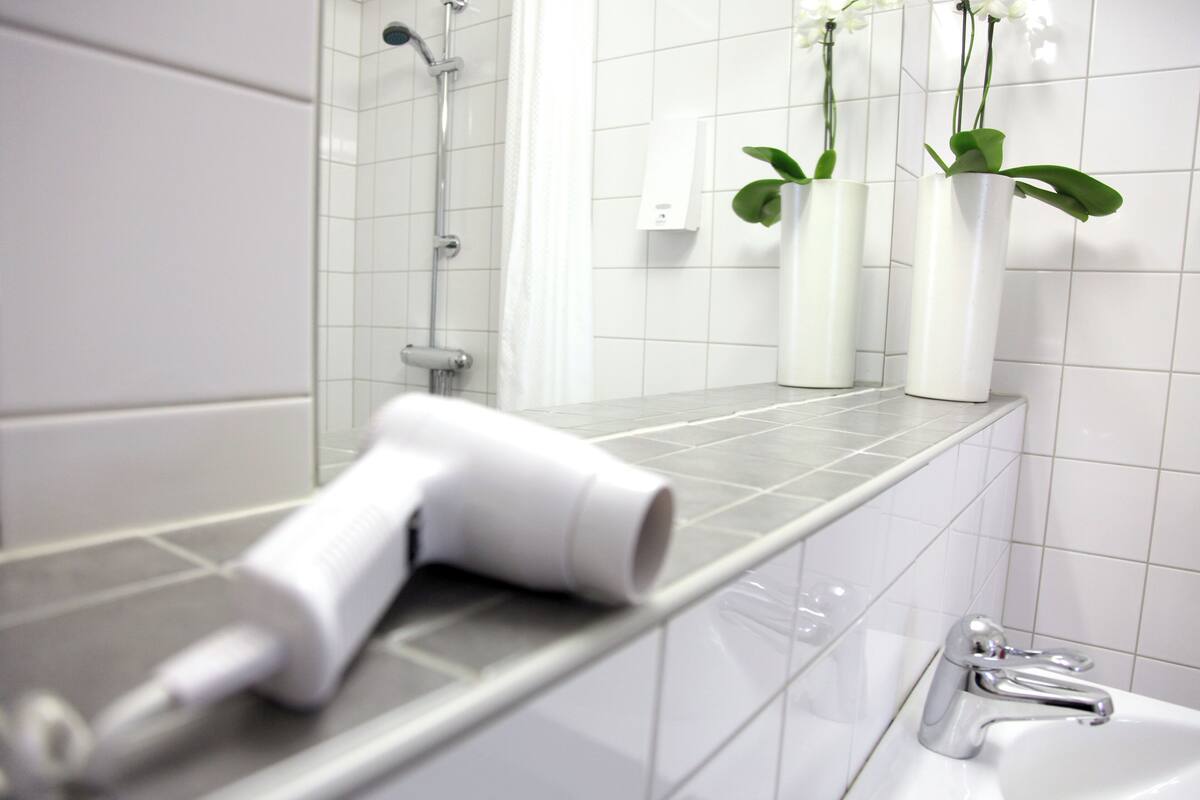 shower, hair dryer, towels, soap