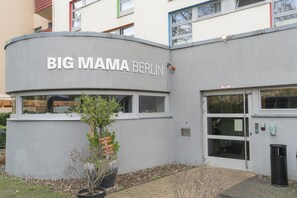 A building with a sign reading "BIG MAMA BERLIN" and a potted plant in front. - BIG MAMA Berlin (Berlin)