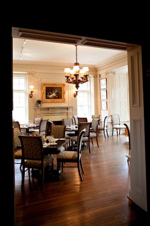 Enjoy meals in style with a classic dining area featuring a dining table, elegant chairs, and a chandelier.
