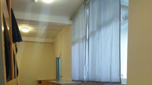 A dormitory room with wooden bunk beds, a small desk, and a window with sheer curtains. - Birmingham Central Backpackers - Hostel (Birmingham)