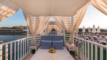 Praia particular, espreguiçadeiras, guarda-sóis, toalhas de praia