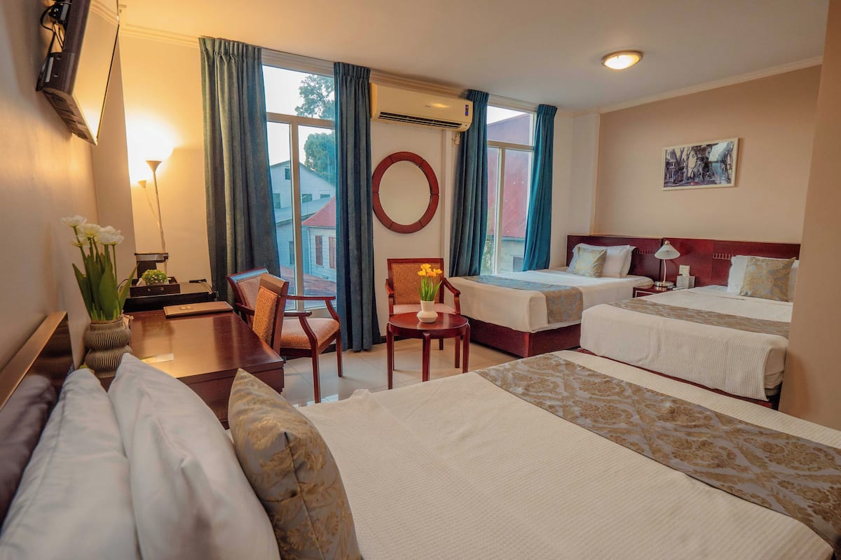 comfort triple room, multiple beds | in-room safe, desk, laptop workspace, blackout curtains