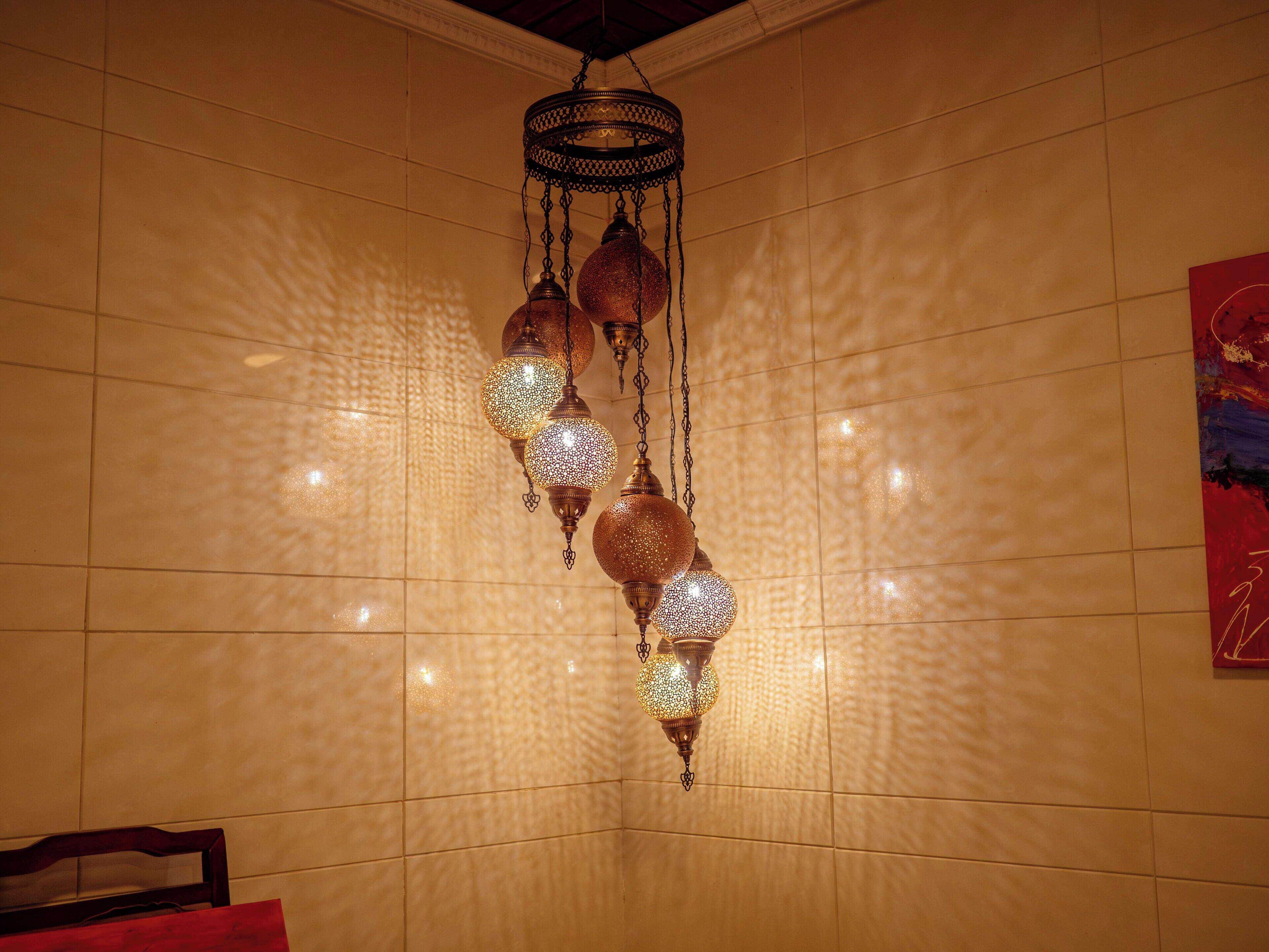 A hanging light fixture with multiple spherical glass elements.