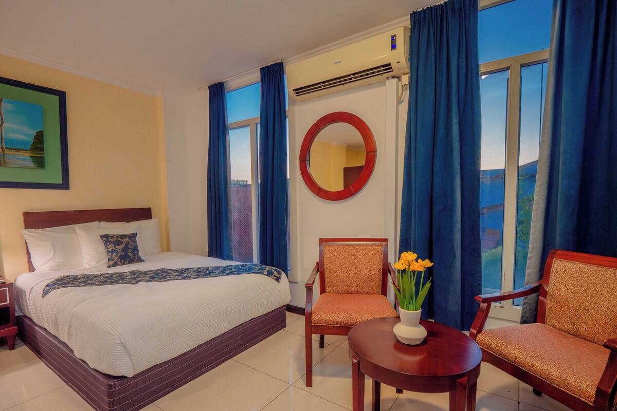 Premium Quadruple Room, 2 Queen Beds | In-room safe, desk, laptop workspace, blackout drapes