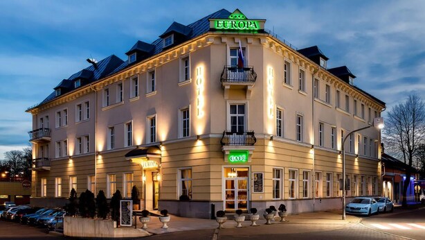 A multi-story hotel with a prominent "EUROPA" sign, a cafe, and a restaurant.