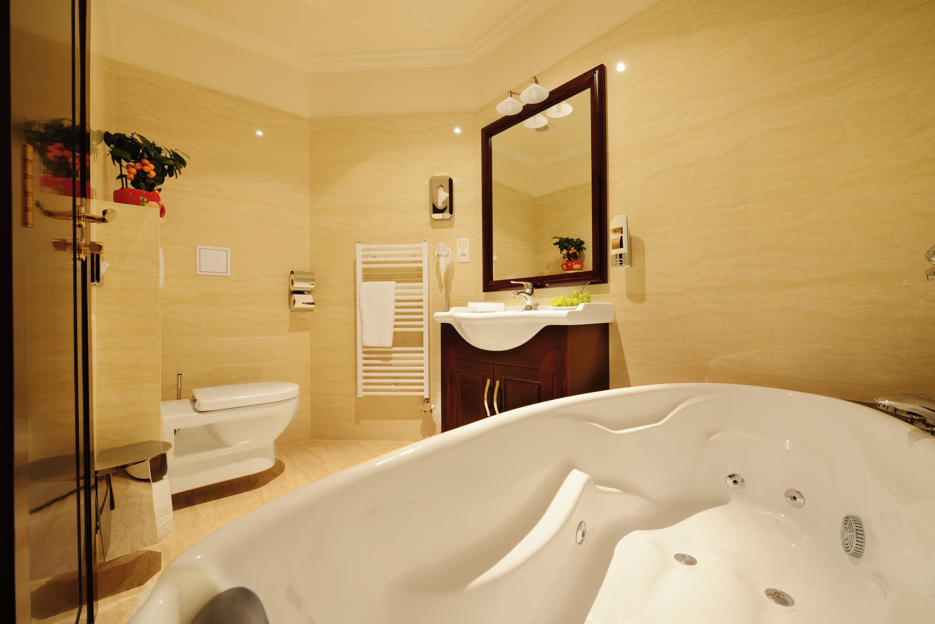 A modern bathroom with a bathtub, toilet, and sink.