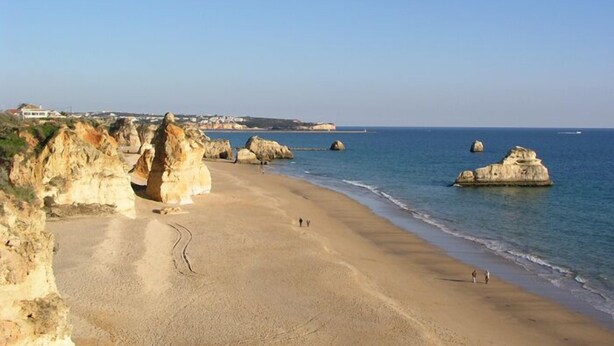 A beach with rocky formations and a clear sky. - Hotel Luar (Portimão)